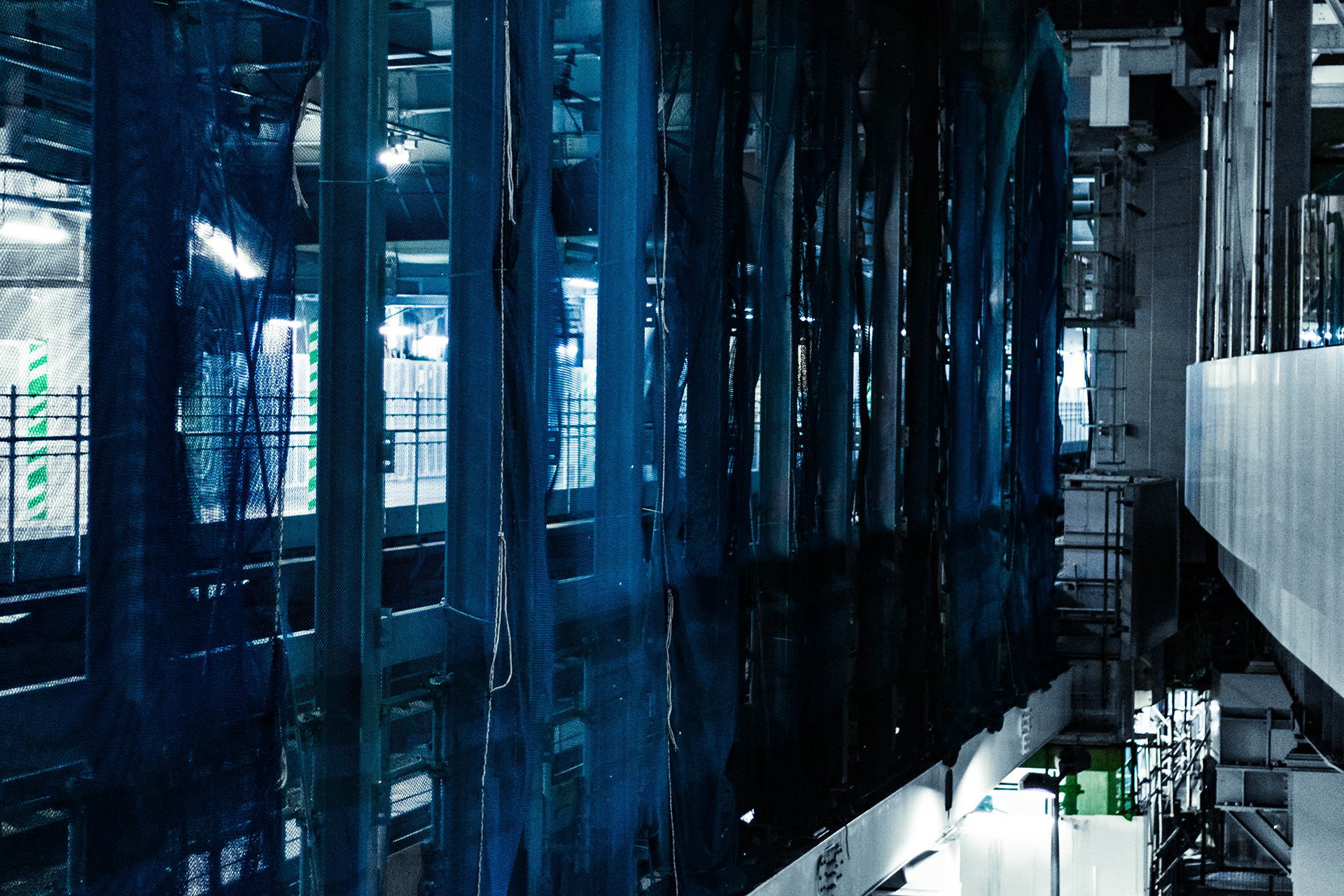 Blue net covering a set of metal support beams.